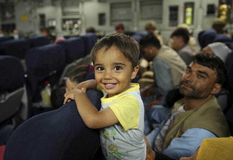 Afghans prepare to to be evacuated aboard a Qatari transport plane, at Hamid Karzai International Airport in Kabul, Afghanistan, August, 18, 2021. Qatar played an out-sized role in U.S. efforts to evacuate tens of thousands of people from Afghanistan. Now the tiny Gulf Arab state is being asked to help shape what is next for Afghanistan because of its ties with both Washington and the Taliban insurgents now in charge in Kabul. (AP Photo)