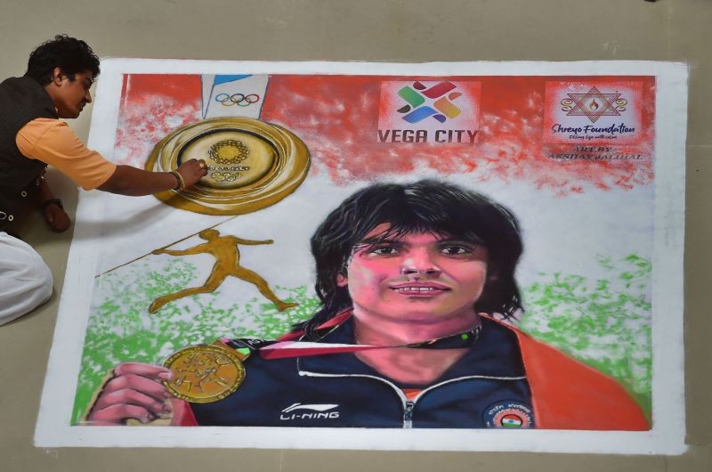 Bengaluru: Rangoli artist Akshay gives finishing touches to a rangoli of gold medal winning athlete Neeraj Chopra, in Bengaluru, Saturday, Aug. 14, 2021. (PTI Photo/Shailendra Bhojak)