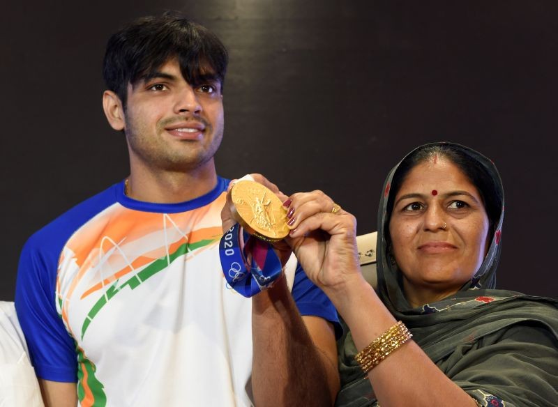 New Delhi: Olympic gold medal winning athlete Neeraj Chopra with his mother Saroj Devi poses for photographs after a press conference in New Delhi, Tuesday, Aug 10, 2021. Chopra won gold in the javelin throw event of the Tokyo 2020. (PTI Photo/Atul Yadav)