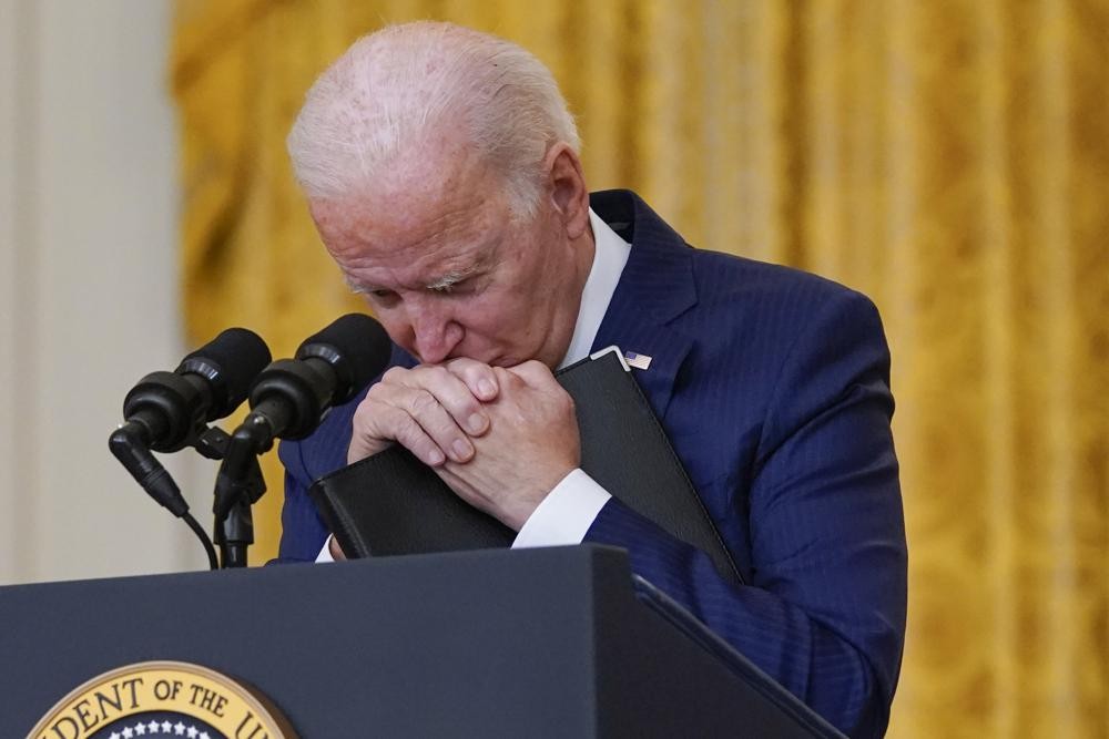 President Joe Biden pauses as he listens to a question about the bombings at the Kabul airport that killed at least 12 U.S. service members, from the East Room of the White House, Thursday, Aug. 26, 2021, in Washington. (AP Photo/Evan Vucci)