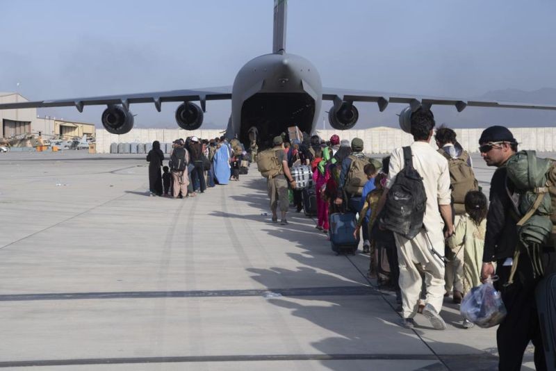 In this image provided by the U.S. Air Force, U.S. Air Force loadmasters and pilots assigned to the 816th Expeditionary Airlift Squadron, load people being evacuated from Afghanistan onto a U.S. Air Force C-17 Globemaster III at Hamid Karzai International Airport in Kabul, Afghanistan on August 24, 2021. (AP Photo)