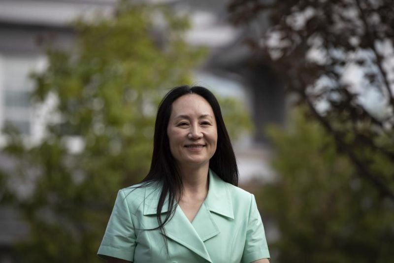 Meng Wanzhou, chief financial officer of Huawei, smiles as she leaves home to attend her extradition hearing at B.C. Supreme Court, in Vancouver, British Columbia on August 9, 2021. (AP Photo)