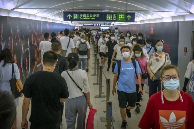 People wearing face masks to help protect against COVID-19 walk through a subway station during the morning rush hour in Beijing on August 4, 2021. China's worst coronavirus outbreak since the start of the pandemic a year and a half ago escalated Wednesday with dozens more cases around the country, the sealing-off of one city and the punishment of its local leaders. (AP Photo)