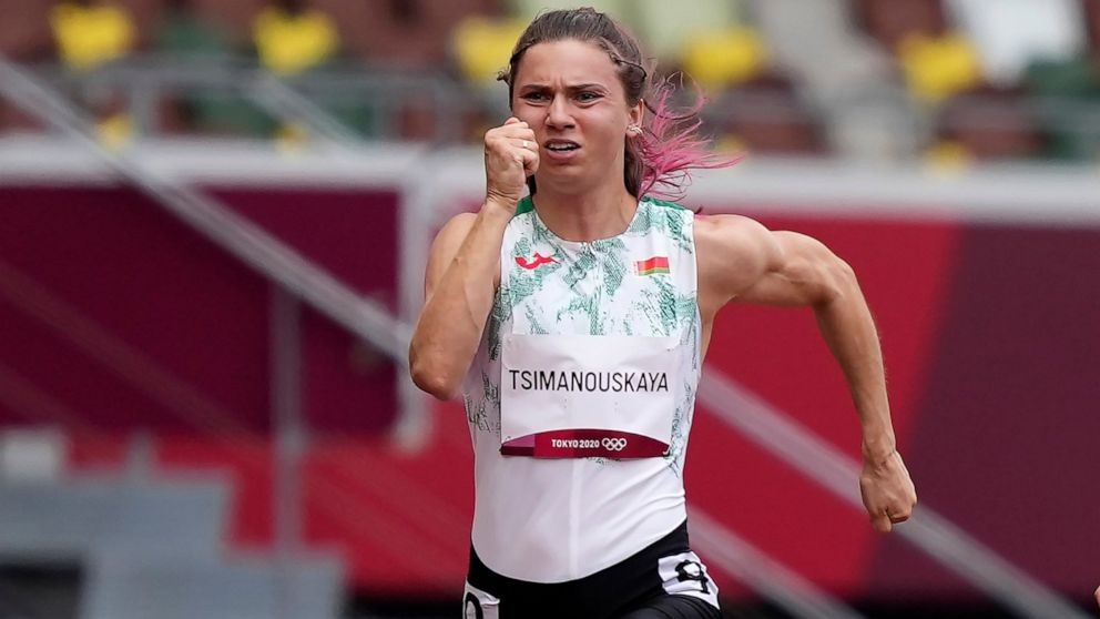 Krystsina Tsimanouskaya, of Belarus, runs in the women's 100-meter run at the 2020 Summer Olympics, Friday, July 30, 2021. Tsimanouskaya alleged her Olympic team tried to remove her from Japan in a dispute that led to a standoff Sunday, Aug. 1, at Tokyo’s main airport. An activist group supporting Tsimanouskaya said she believed her life was in danger in Belarus and would seek asylum with the Austrian embassy in Tokyo. (AP Photo)