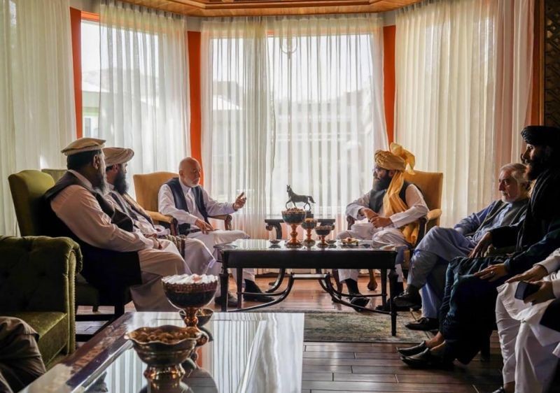 In this handout photograph released by the Taliban, former Afghan President Hamid Karzai, center left, senior Haqqani group leader Anas Haqqani, center right, Abdullah Abdullah, second right, head of Afghanistan's National Reconciliation Council and former government negotiator with the Taliban, and others in the Taliban delegation, meet in Kabul, Afghanistan on August 18, 2021. The meeting comes after the Taliban's lightning offensive saw the militants seize the capital, Kabul. (AP Photo)