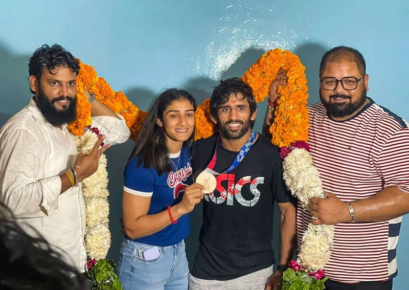 Sonipat: Bronze medalist in Tokyo Olympics, wrestler Bajrang Punia with his wife Sangeeta Phogat late yesterday night, at his residence in Sonipat, Monday, Aug 9, 2021. (PTI Photo)