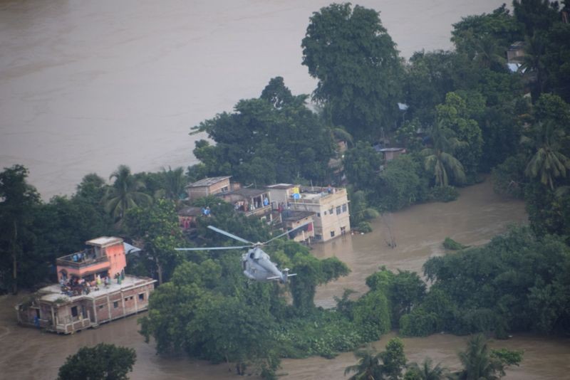 An Indian Air Force (IAF) helicopter during a rescue operation at a flood affected area of Khanakul in Hoogly district. (PTI Photo)