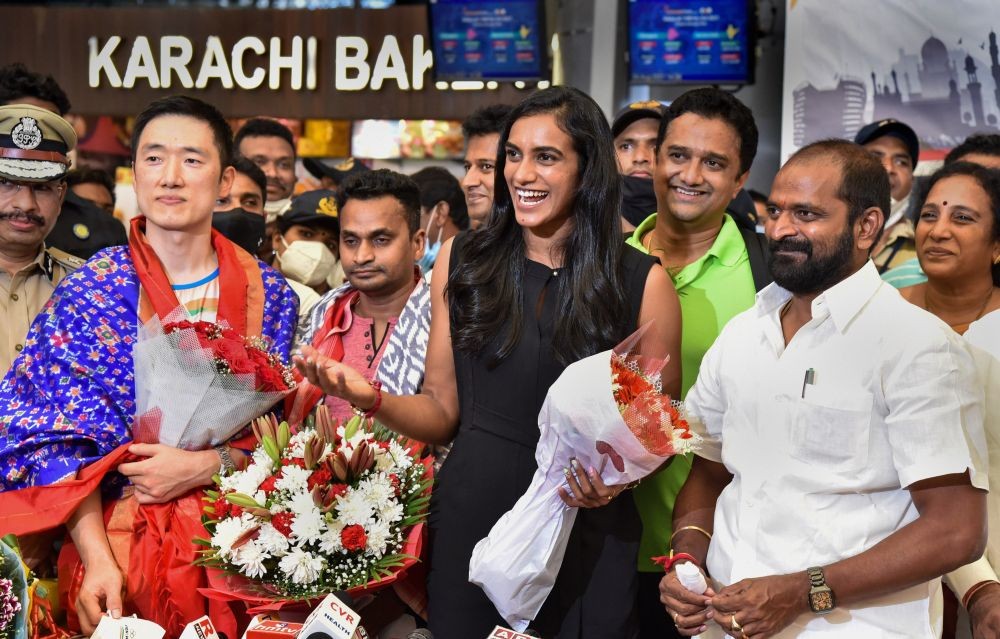 Hyderabad: Telangana Sports, Culture and Tourism Minister V. Srinivas Goud welcomes Bronze medalist in Tokyo Olympics 2020, Badminton player PV Sindhu on her arrival at Shamshabad airport in Hyderabad, Wednesday, Aug. 4, 2021. (PTI Photo)