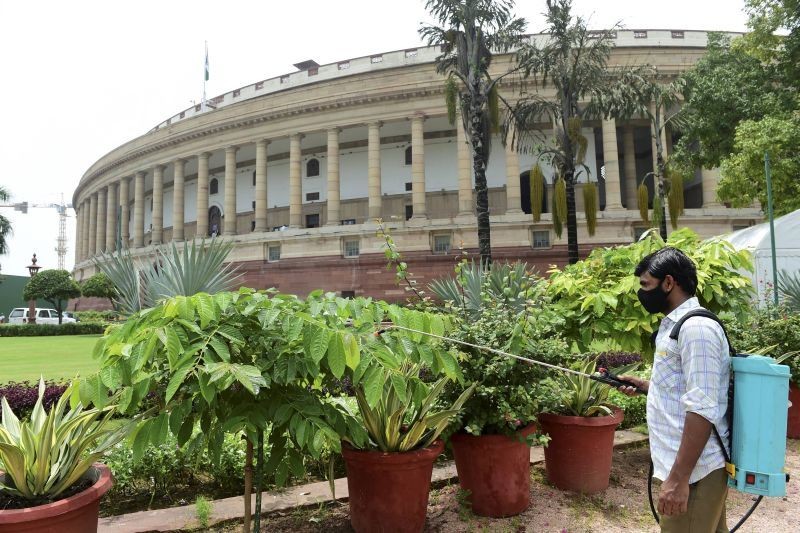 A worker sanitises the Parliament complex during its Monsoon Session, in New Delhi. (PTI File Photo)