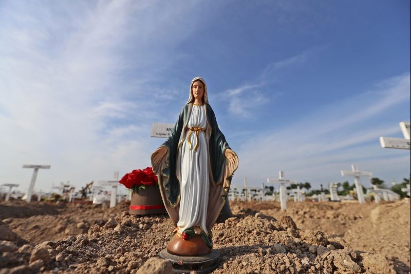 akarta : A statue of Virgin Mary is placed on the grave of a woman who died of COVID-19 at Rorotan Cemetery in Jakarta, Indonesia, Wednesday, Sept. 1, 2021. In the graveyard on Jakarta's outskirts, portraits of the dead, bouquets of flowers and other mementos serve as reminders of the deadly coronavirus wave that battered Indonesia over the summer. AP/PTI