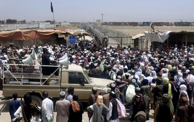 In this July 17, 2021 file photo, Pakistani soldiers stand guard while stranded people move to cross border through Pakistan Afghan border crossing point in Chaman, Pakistan. (AP File Photo)