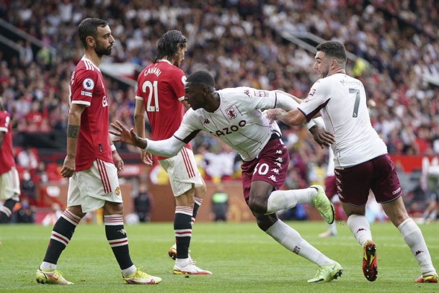 Aston Villa players celebrate after scoring a opening goal against Manchester United during their English Premier League match at the Old Trafford stadium in Manchester, England, Saturday, Sept 25, 2021. | AP Photo/Jon Super