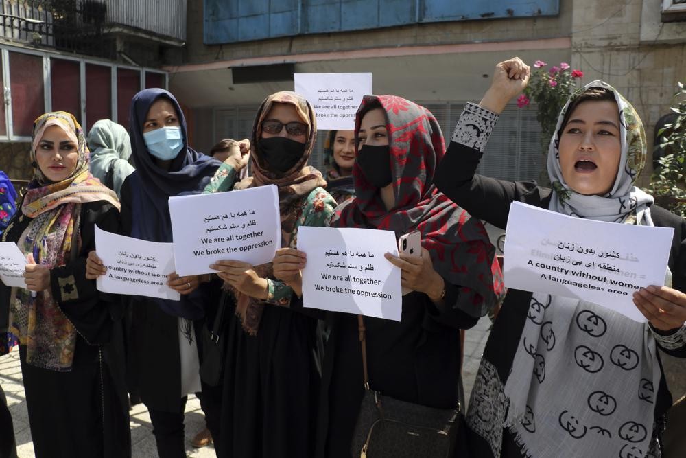 Women gather to demand their rights under the Taliban rule during a protest in Kabul, Afghanistan, Friday, Sept. 3, 2021. As the world watches intently for clues on how the Taliban will govern, their treatment of the media will be a key indicator, along with their policies toward women. When they ruled Afghanistan between 1996-2001, they enforced a harsh interpretation of Islam, barring girls and women from schools and public life, and brutally suppressing dissent. (AP Photo/Wali Sabawoon)