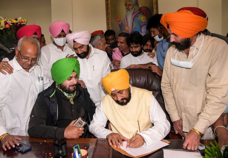 New Punjab Chief Minister Charanjit Singh Channi takes charge of the office, in Chandigarh on September 20, 2021. PPCC President Navjot Singh Sidhu is also seen. (PTI Photo)