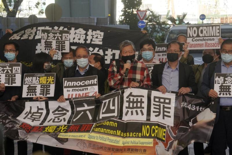 In this Feb. 5, 2021, file photo, various groups of pro-democracy activists, including Lee Cheuk-Yan, center, arrive at a court after being charged of joining an unauthorized assembly on a vigil last June 4 to commemorate the anniversary of the 1989 Tiananmen crackdown in Hong Kong. The banner reads "Innocent to mourn June 4". Nine Hong Kong activists and ex-lawmakers were handed jail sentences of up to 10 months on Wednesday, Sept. 15, 2021, over their roles in last year's banned Tiananmen candlelight vigil, the latest blow in an ongoing crackdown on dissent in Hong Kong. (AP File Photo)