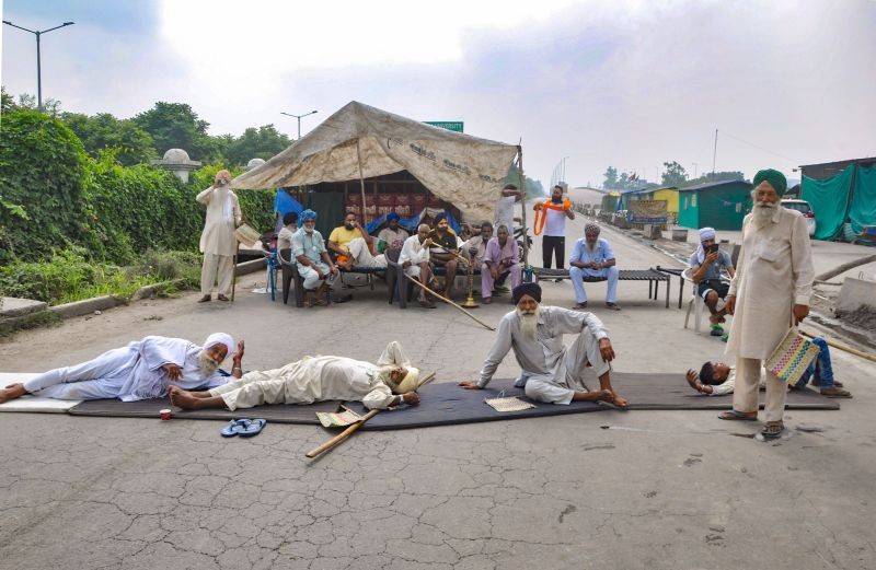 Farmers block the Sonipat-Panipat road during their 'Bharat Bandh' against central government's three farm reform laws, in Sonipat on September 27, 2021. (PTI Photo)