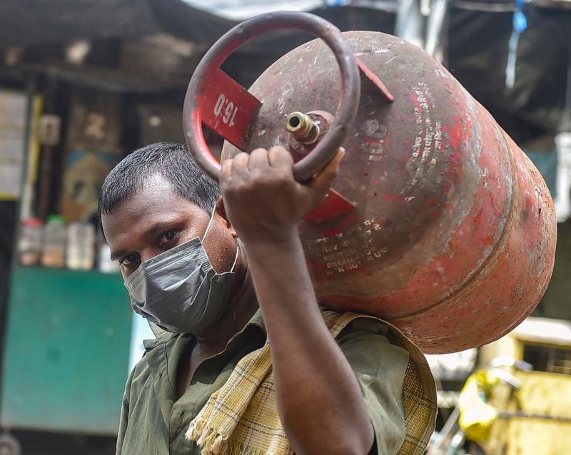 Kolkata: A worker carries an LPG gas cylinder, in Kolkata, Wednesday, Sept 1, 2021. The price of non-subsidised LPG cylinders has been hiked by Rs 25 effective from 1st September. (PTI Photo)