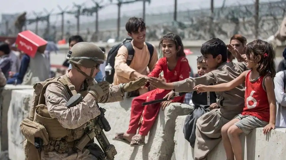 As in any calamity, children are the most helpless. And the Afghan crisis is no different. Several heartrendering pictures have emerged from the disaster. In this image provided by the US Marine Corps, a Marine with Special Purpose Marine Air-Ground Task Force-Crisis Response-Central Command (SPMAGTF-CR-CC) plays with children waiting during an evacuation at Hamid Karzai International Airport in Kabul, Afghanistan. (PTI File Photo)