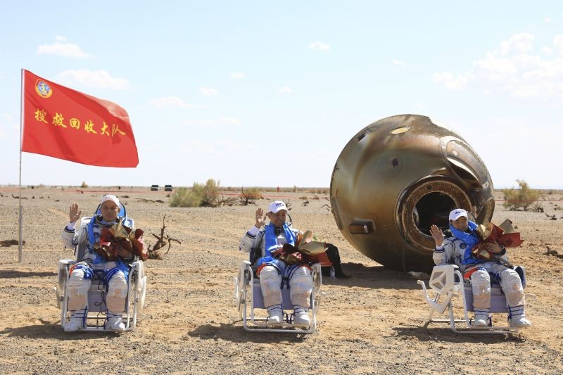 In this photo released by Xinhua News Agency, Chinese astronauts from left, Tang Hongbo, Nie Haisheng and Liu Boming wave at the Dongfeng landing site in northern China's Inner Mongolia Autonomous Region on September 17, 2021. The trio of Chinese astronauts returned to Earth on Friday after a 90-day stay aboard their nation's first space station in China's longest mission yet. (AP/PTI Photo)