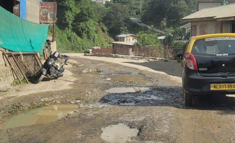A local taxi passes through a pothole-ridden stretch along the Tinpati- Don Bosco school road in Kohima on September 14. (Morung Photo by Chizokho Vero)