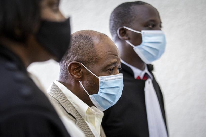 In this Monday, Sept. 14, 2020 file photo, Paul Rusesabagina, center, whose story inspired the film "Hotel Rwanda" for saving people from genocide, appears at the Kicukiro Primary Court in the capital Kigali, Rwanda. A court in Rwanda said Monday, Sept. 20, 2021 that Rusesabagina, who boycotted the announcement after declaring he didn't expect justice in a trial he called a "sham", is guilty of terror-related offenses. (AP File Photo)