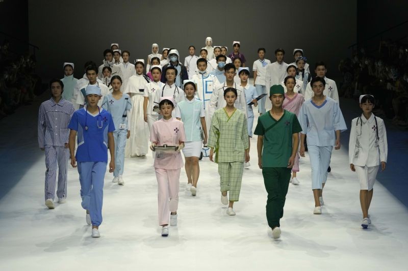 Beijing: Models wear fashionable medical wear designed by BIFT X DISHANG Group in a joint fashion show of medical uniform entitled "Heroes in Harm's Way," a tribute to the frontline workers against the COVID-19 pandemic, during China Fashion Week held in Beijing, China, Saturday, Sept. 11, 2021. AP/PTI