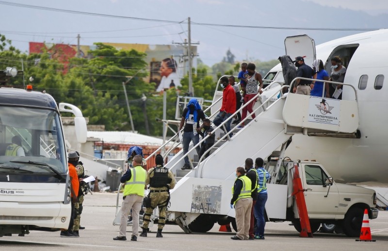 Haitians who were deported from the United States deplane at the Toussaint Louverture International Airport, in Port au Prince, Haiti.(AP/PTI Photo)