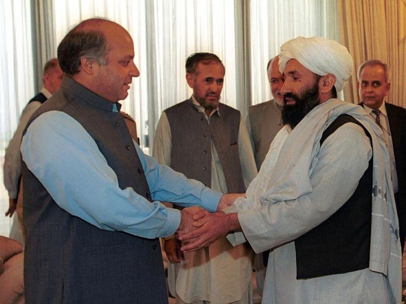 In this Aug. 25, 1999 file photo, Mullah Hasan Akhund, right, then Afghanistan's Foreign Minister is received by then Pakistan Prime Minister Nawaz Sharif, in Islamabad. The Taliban on Tuesday, September 7, 2021, announced a caretaker Cabinet that paid homage to the old guard of the group, giving top posts to Taliban personalities who dominated the 20-year battle against the U.S.-led coalition and its Afghan government allies. Akhund who was named Interim Afghan Prime Minister on Tuesday, headed the Taliban government in Kabul during the last years of its rule. (AP File Photo)