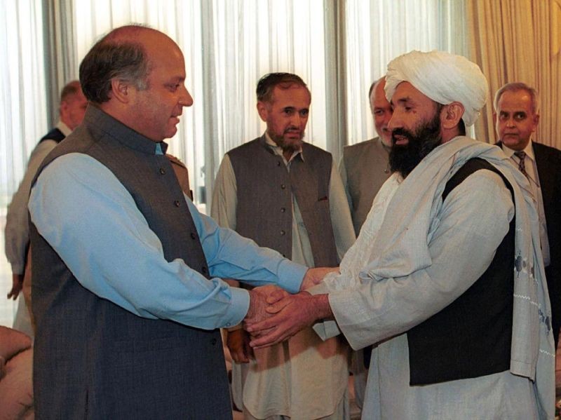 In this Aug. 25, 1999 file photo, Mullah Hasan Akhund, right, then Afghanistan's Foreign Minister is received by then Pakistan Prime Minister Nawaz Sharif, in Islamabad. The Taliban on Tuesday, September 7, 2021, announced a caretaker Cabinet that paid homage to the old guard of the group, giving top posts to Taliban personalities who dominated the 20-year battle against the U.S.-led coalition and its Afghan government allies. Akhund who was named Interim Afghan Prime Minister on Tuesday, headed the Taliban government in Kabul during the last years of its rule. (AP File Photo)