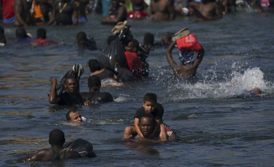 Ciudad AcuÃ±a: Migrants wade back and forth across the Rio Grande from Ciudad AcuÃ±a, Mexico, to Del Rio, Texas, Monday, Sept. 20, 2021. The U.S. is flying Haitians camped in a Texas border town back to their homeland and blocking others from crossing the border from Mexico.AP/PTI Photo