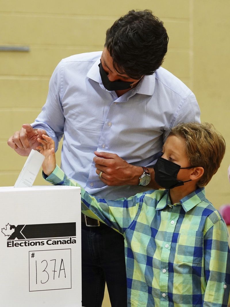 Liberal leader Justin Trudeau casts his ballot in the 44th general federal election as he's joined by his son Hadrien in Montreal on September 20, 2021. (AP/PTI Photo)
