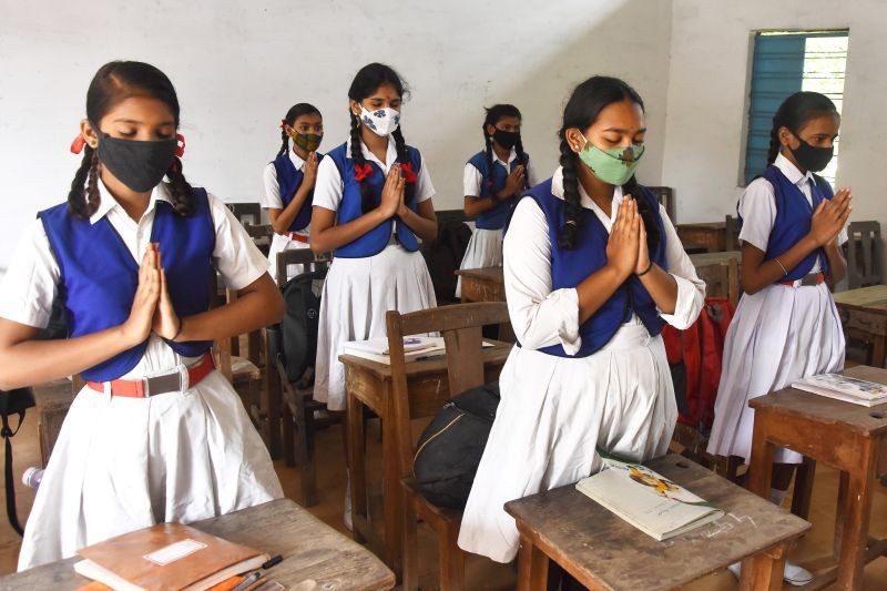 Jabalpur: Students wearing face masks attend prayer in a class at a school that was reopened after further ease in COVID-19 restrictions, in Jabalpur, Wednesday, Sept. 1, 2021. (PTI Photo)