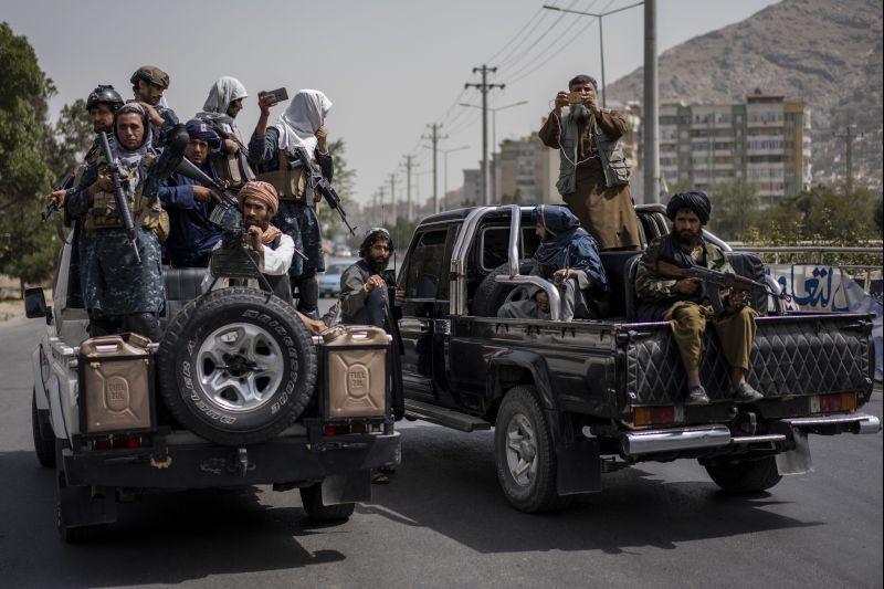 Taliban fighters escort women's march in support of the Taliban government outside Kabul University, Afghanistan, on September 11, 2021. (AP/PTI Photo)