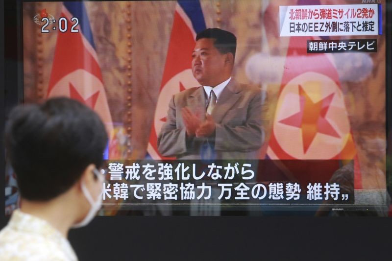 A man walks past a TV screen showing North Korean leader Kim Jong Un, in Tokyo on September 15, 2021. North Korea fired two ballistic missiles into waters off its eastern coast Wednesday afternoon, two days after claiming to have tested a newly developed missile in a resumption of its weapons displays after a six-month lull. (AP/PTI Photo)