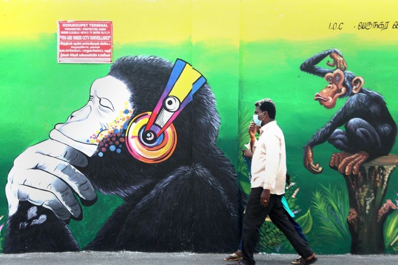 Chennai: A man walks past a wall mural in Chennai, Saturday, Sept. 18, 2021. (PTI Photo)