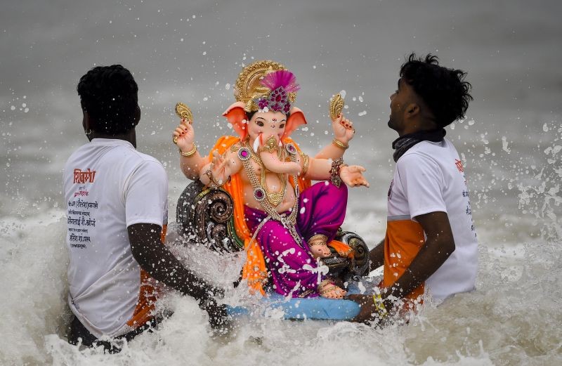 Mumbai: A volunteer immerses an idol of Lord Ganesha in the Arabian Sea on the 5th day during the Ganesh festival in Mumbai, Tuesday, Sept. 14, 2021. (PTI Photo/Kunal Patil)(
