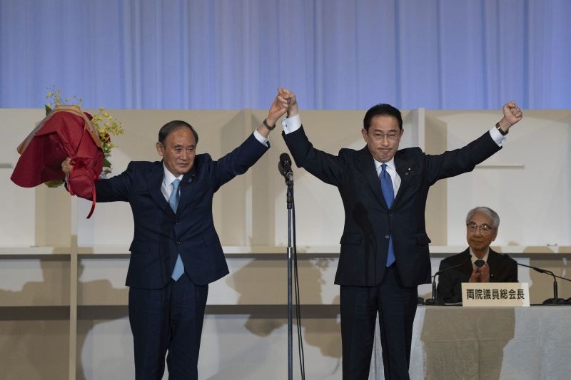 Japanese former Foreign Minister Fumio Kishida, right, celebrates with outgoing Prime Minister Yoshihide Suga after being announced the winner of the Liberal Democrat Party leadership election in Tokyo on September 29, 2021. Kishida has won the governing party leadership election and is set to be become the next prime minister. (AP/PTI Photo)