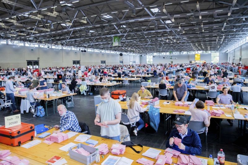 Election workers open the pink envelopes during the counting of the postal vote for the Germany parliament election, in Cologne, Germany on September 26. German voters are choosing a new parliament in an election that will determine who succeeds Chancellor Angela Merkel after her 16 years at the helm of Europe's biggest economy. (AP/PTI Photo)
