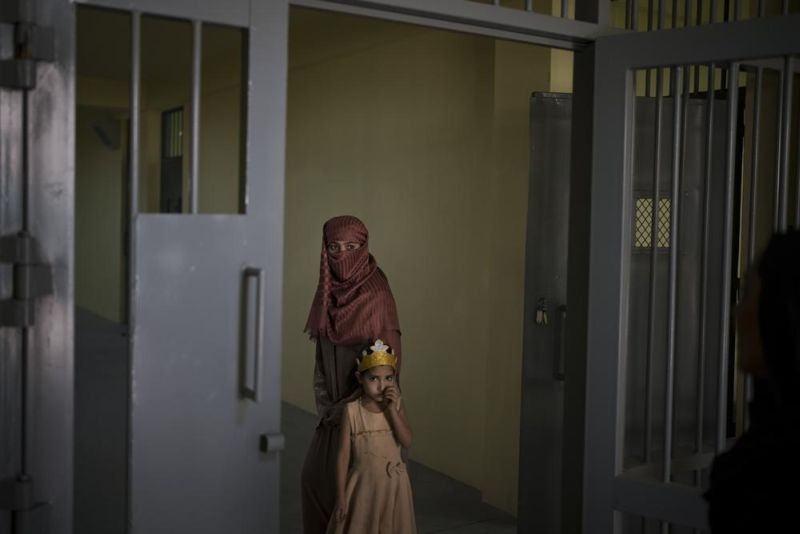 Razia and her 6-year-old daughter Alia, stand inside the women's section of the Pul-e-Charkhi prison in Kabul, Afghanistan, Thursday, Sept. 23, 2021. When the Taliban took control of a northern Afghan city of Pul-e-Kumri the operator of the only women's shelter ran away, abandoning 20 women in it. When the Taliban arrived at the shelter the women were given two choices: Return to their abusive families, or go with the Taliban, With nowhere to put the women, the Taliban took them to the abandoned women's section of Afghanistan's notorious Pul-e-Charkhi prison. (AP Photo)