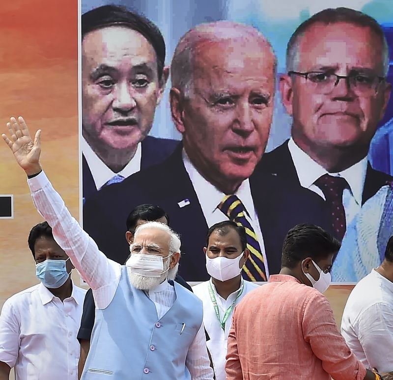 Prime Minister Narendra Modi waves to supporters on his arrival from US, after concluding Quad Summit, at AFS Palam in New Delhi on September 26, 2021. (PTI Photo)