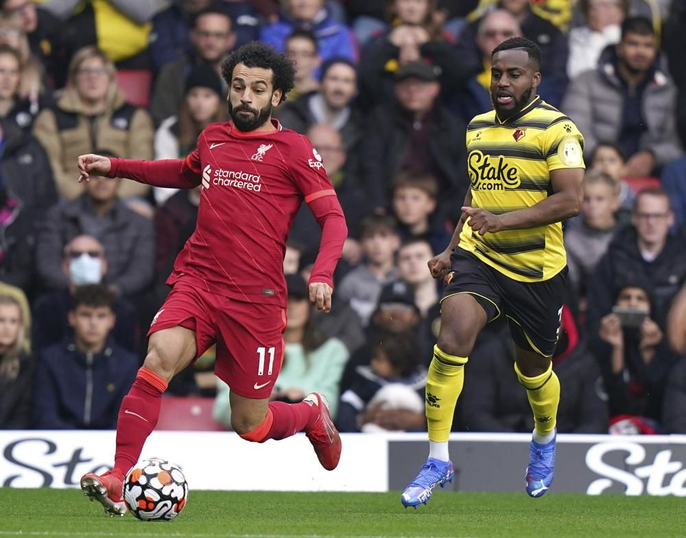 Liverpool's Mohamed Salah, left, and Watford's Danny Rose battle for the ball during the English Premier League soccer match between Watford and Liverpool at Vicarage Road, Watford, England, Saturday, Oct. 16, 2021. (Tess Derry/PA via AP)