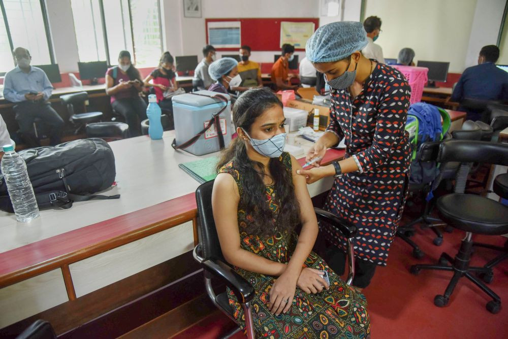 Navi Mumbai: A beneficiary receives a dose of COVID-19 vaccination during a special vaccination drive by Navi Mumbai Municipal Corporation (NMMC) for students of Karmveer Bhaurao Patil College, in Navi Mumbai, Friday, Oct. 22, 2021. (PTI Photo)