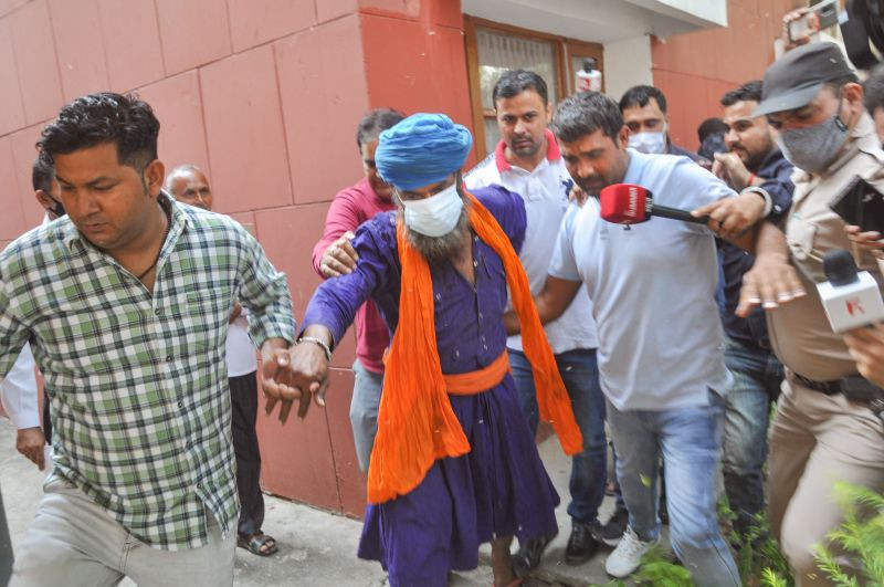 Sarabjit Singh, accused in the murder of Lakhbir Singh near farmers' protest at Kundli border, being taken back to police custody after the court ordered for his 7-day remand, in Sonipat, Saturday, Oct. 16, 2021. (PTI Photo)