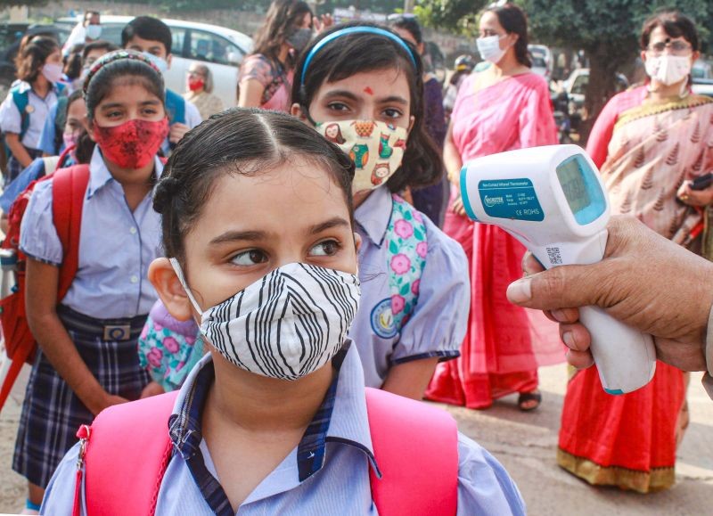 Gurugram: Students undergo thermal screening after authorities allowed schools to conduct classes for students of 1st to 5th standard as part of easing of COVID-19 induced restrictions, in Gurugram, Tuesday, Oct. 5, 2021. (PTI Photo)