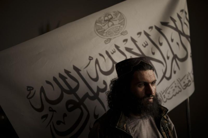 In this Sept. 20, 2021 file photo, Taliban district police chief Shirullah Badri stands in front of a Taliban flag during an interview at his office in Kabul, Afghanistan. The Islamic State in Afghanistan, emerged in 2015 when the group was at it's peak, controlling vast swathes of territory in Iraq and Syria. Now, with the U.S. exit from Afghanistan, IS is poised to usher in another violent phase - except this time it is the Taliban playing the the role of the state. (AP File Photo)