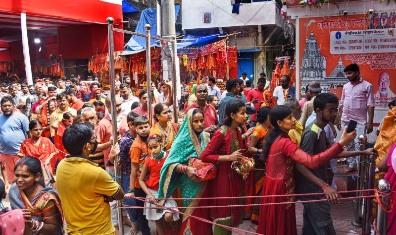 Devotees in large numbers wait in queues to offer prayers at Patan Devi temple during Navratri festival in Patna on October 10, 2021. (PTI Photo)