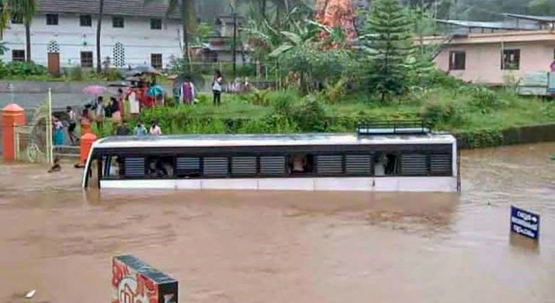 Kottayam: A bus partially submerged in a waterlogged area following heavy rains at Poonjaar in Kottayam, Saturday, Oct. 16, 2021. (PTI Photo)