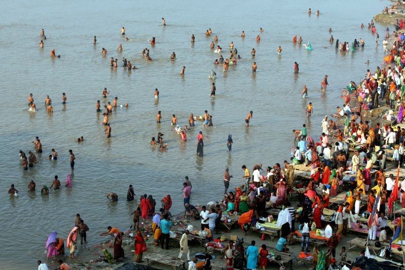 Devotees take a holy dip in the Ganga river on the first day of the 'Navratri' festival in Prayagraj on October 7, 2021. (PTI Photo) 