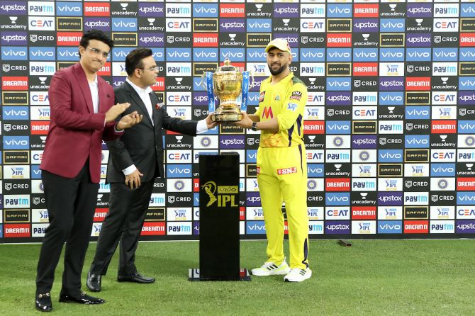 Chennai Super Kings captain Mahendra Singh Dhoni receives the IPL winner’s trophy from BCCI secretary Jay Shah as BCCI president Sourav Ganguly applauds. Photograph: BCCI