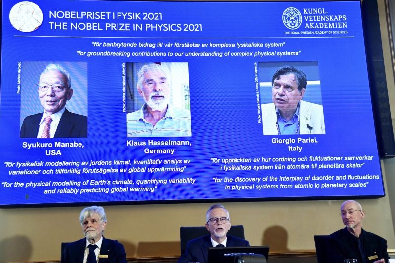 Secretary General of the Royal Swedish Academy of Sciences Goran Hansson, center, flanked at left by member of the Nobel Committee for Physics Thors Hans Hansson, and member of the Nobel Committee for Physics John Wettlaufer, right, announces the winners of the 2021 Nobel Prize in Physics at the Royal Swedish Academy of Sciences, in Stockholm, Sweden on October 5, 2021. The Nobel Prize for physics has been awarded to scientists from Japan, Germany and Italy. Syukuro Manabe and Klaus Hasselmann were cited for their work in "the physical modeling of Earth's climate, quantifying variability and reliably predicting global warming". The second half of the prize was awarded to Giorgio Parisi for "the discovery of the interplay of disorder and fluctuations in physical systems from atomic to planetary scales." (AP/PTI Photo)